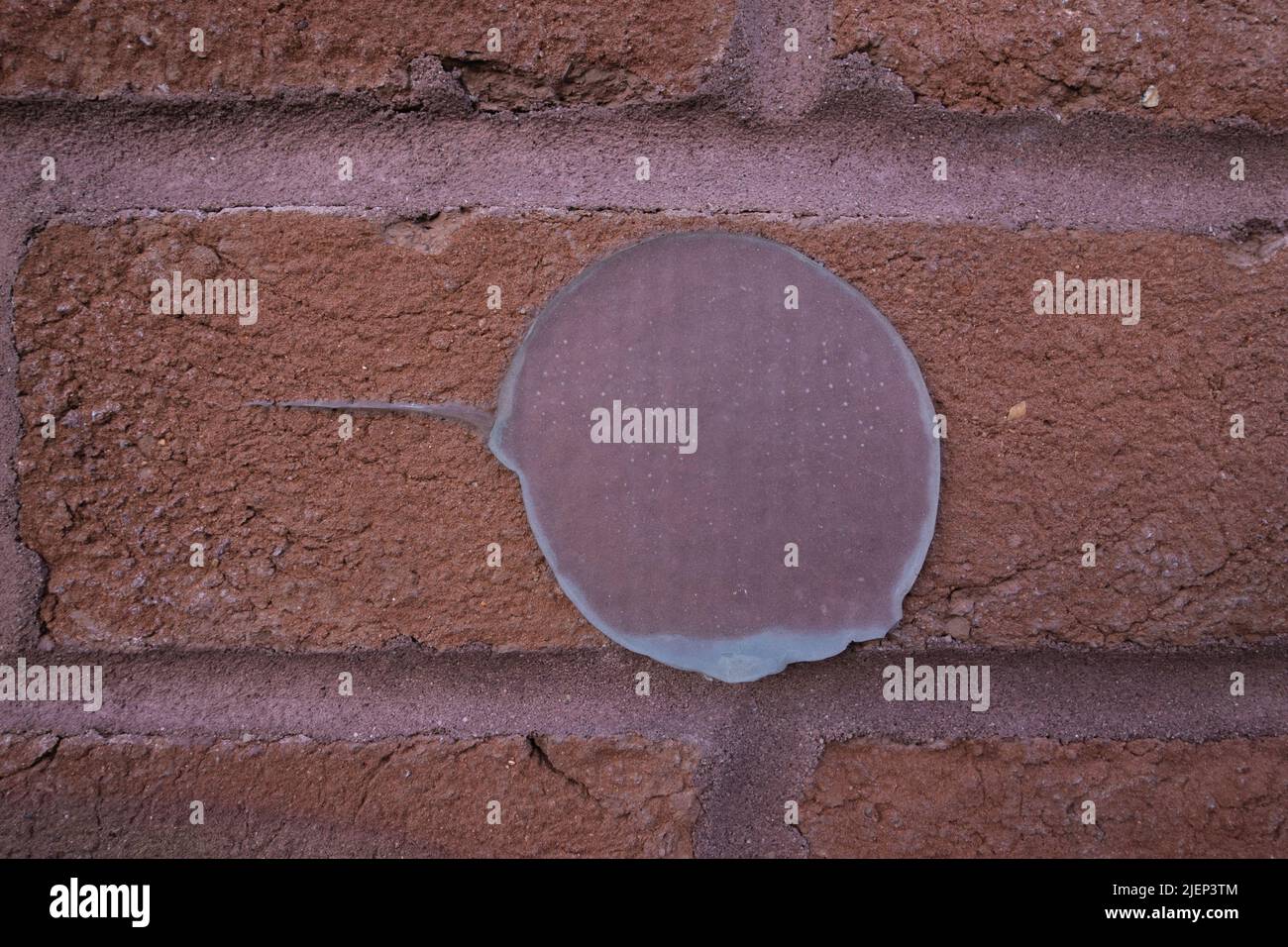 circular abstract silicone adhesive on a brick wall Stock Photo Alamy