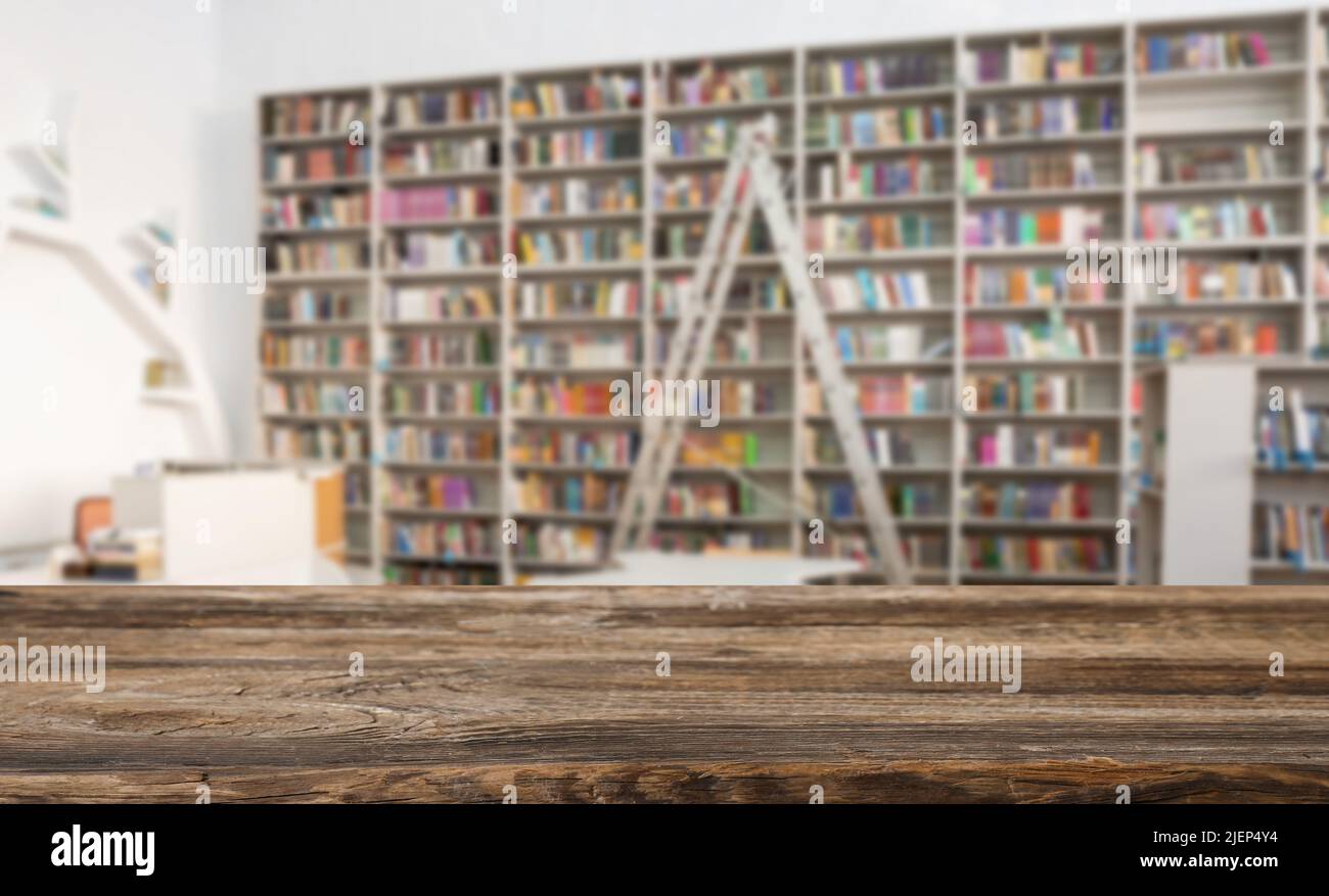 Empty wooden table in modern library Stock Photo - Alamy