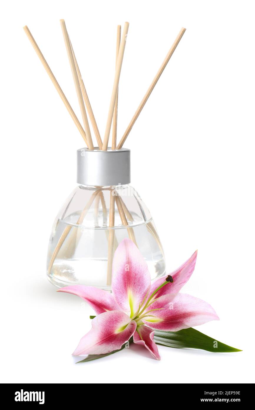Reed diffuser and lily on white background Stock Photo - Alamy