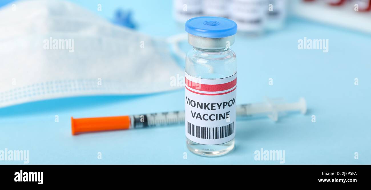 Monkeypox vaccine and syringe on light blue background, closeup Stock ...