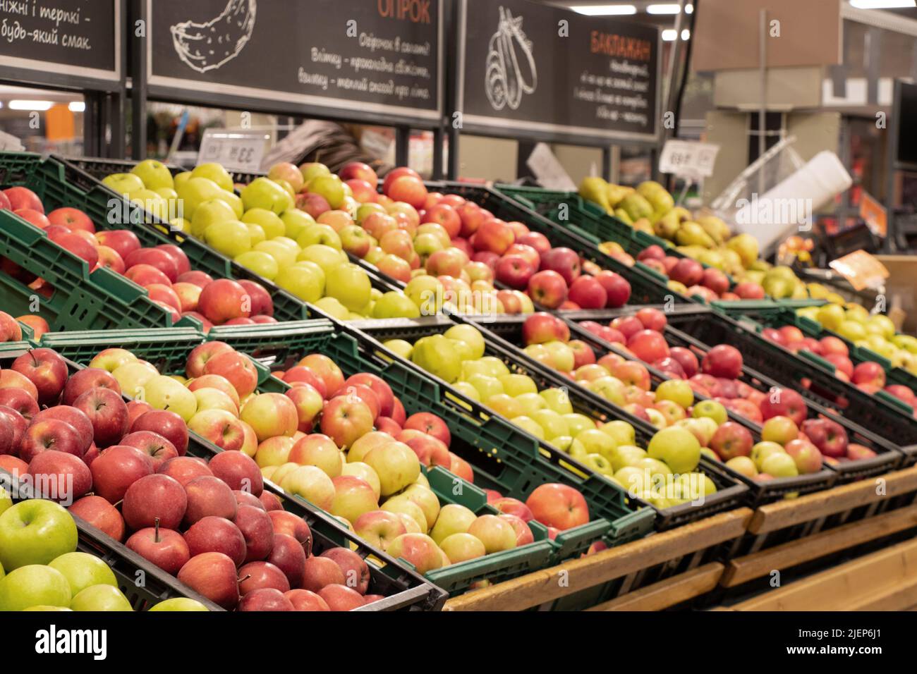 apples in a supermarket on showcases in boxes, fruits in a store for