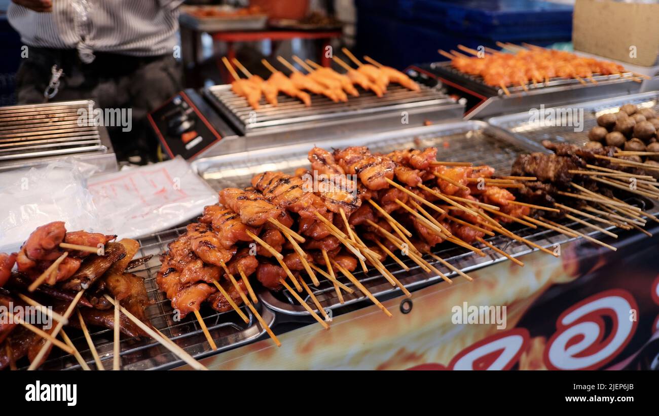 Hot Satay BBQ meat sticks from street vendor Bangkok Thailand Stock Photo