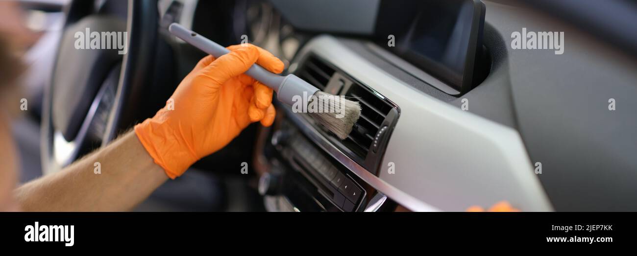 Hands in gloves with a dust brush, detailing Stock Photo