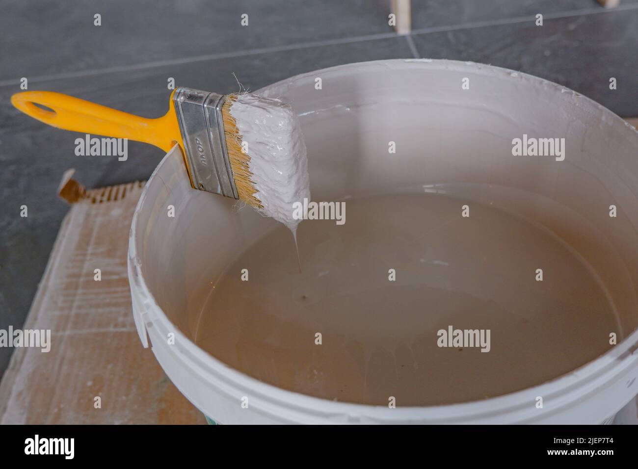 the paint brush is fixed in a bucket above the paint.construction works