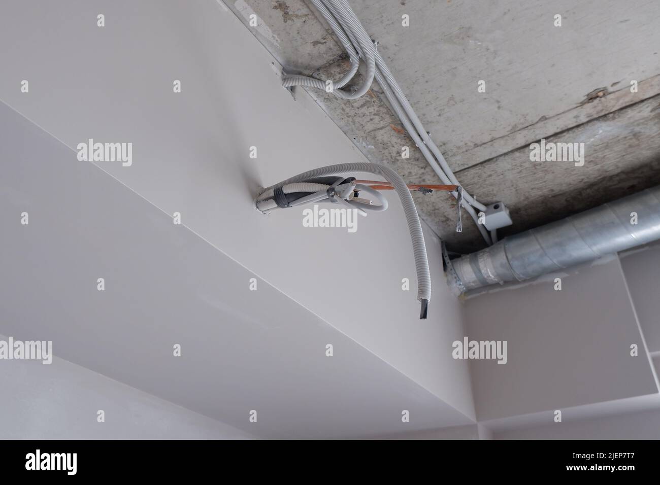 the wiring for the air conditioner sticks out of the wall Stock Photo