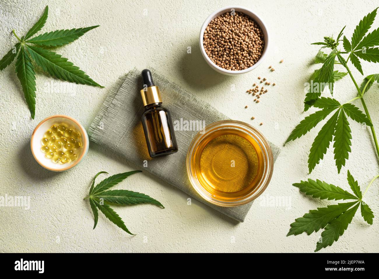 Hemp oil, leaves and seeds, cbd oil in bottle and capsules, alternative medicine and organic skin care concept. Stock Photo