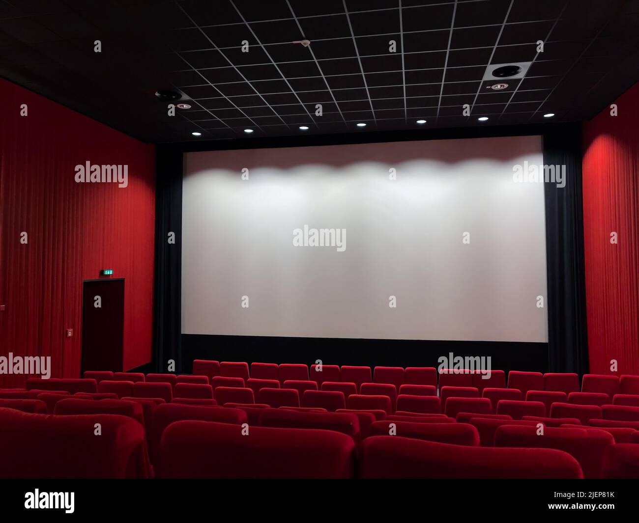 Cinema Screen  And Red Seats. Empty Screening Theater Stock Photo
