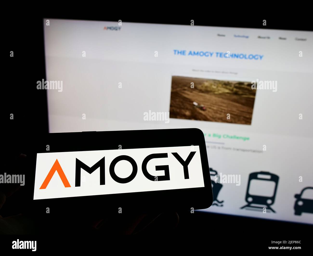 Person holding mobile phone with logo of American ammonia fuel company Amogy Inc. on screen in front of business web page. Focus on phone display. Stock Photo