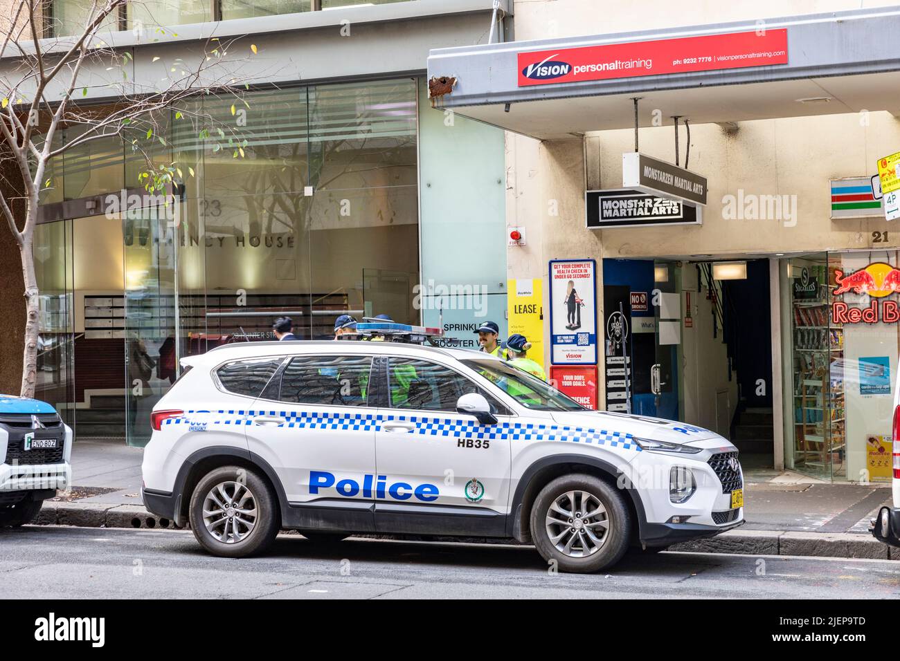 Australian NSW Police car parked in Sydney with police officers stood beside the police vehicle,Sydney,NSW,Australia Stock Photo