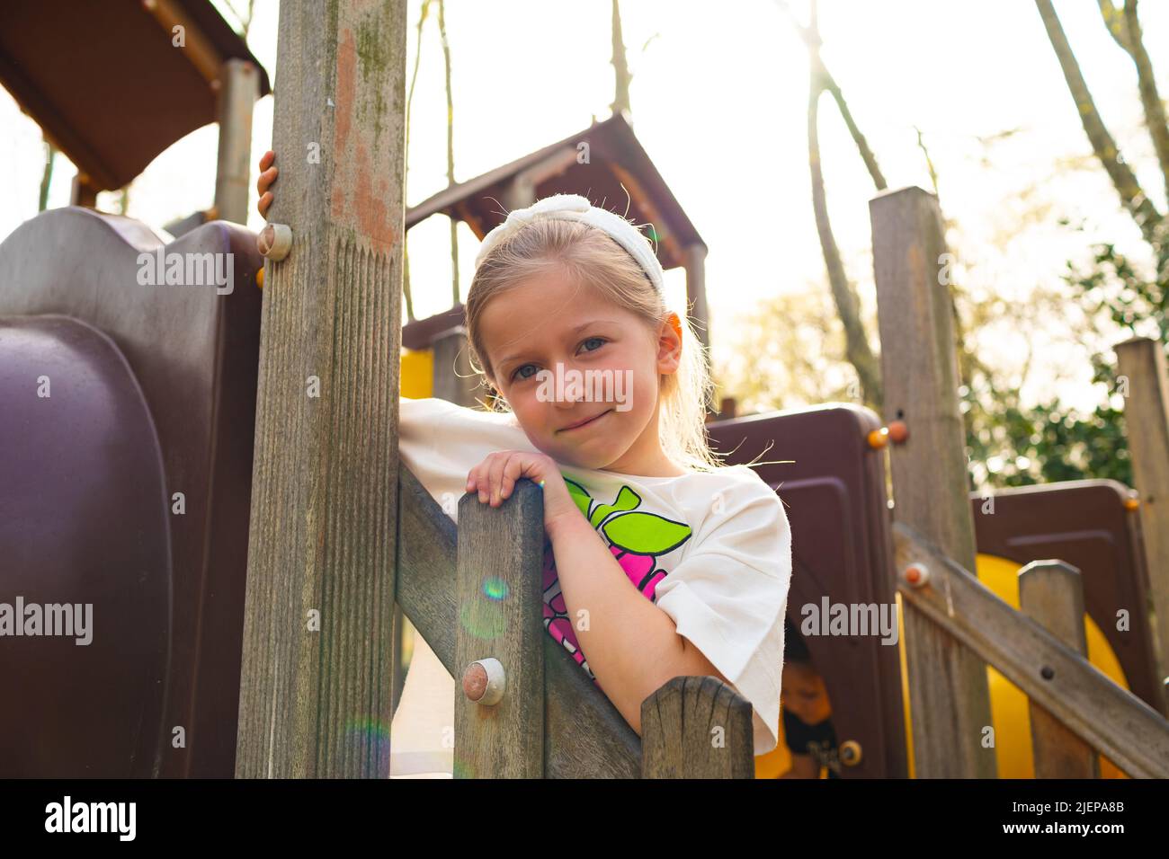 Active blonde little girl playing on a playground Stock Photo - Alamy