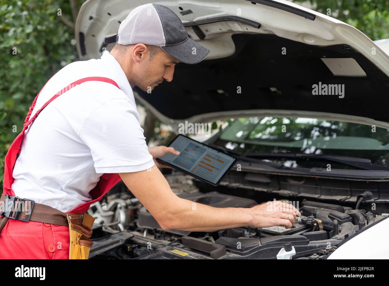 mechanic using digital tablet in workshop Stock Photo