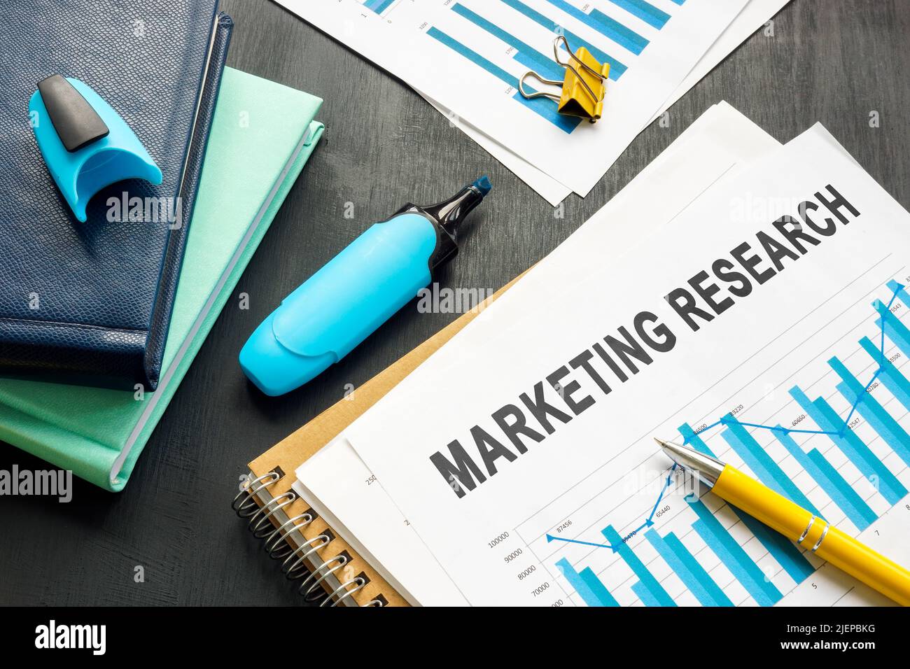 Marketing research report with charts and notepads. Stock Photo