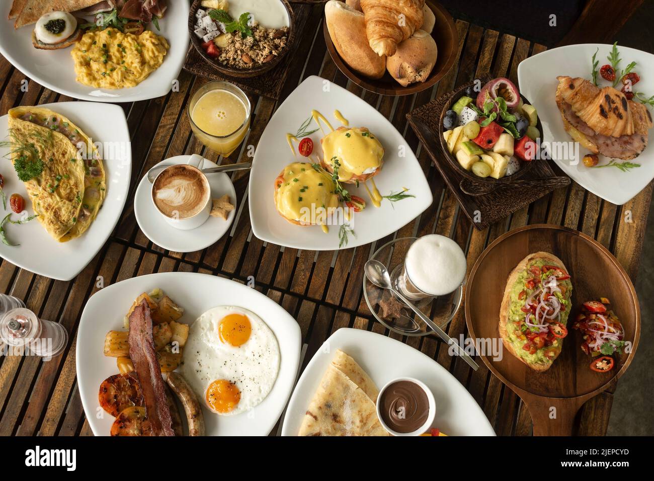 many mixed western breakfast food items on cafe table Stock Photo