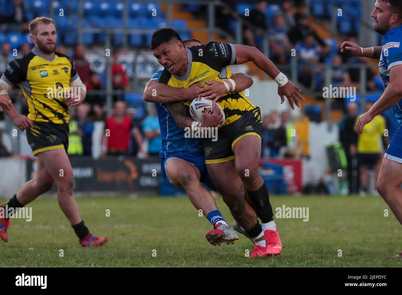 Halifax Panthers Adam Tangata is tackled by a Barrow Raiders defender during the Betfred Championship match between Barrow RLFC and Halifax RLFC at Craven Park, Barrow on 27 June 2022. Photo by Simon Hall. Editorial use only, license required for commercial use. No use in betting, games or a single club/league/player publications. Credit: UK Sports Pics Ltd/Alamy Live News Stock Photo