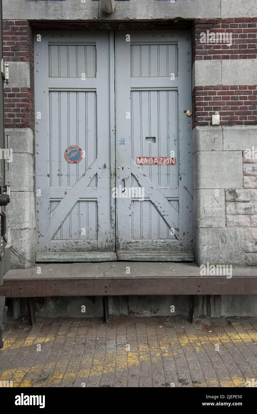 Rotterdam, Netherlands. Double, wooden door giving accent to the warehouse section former industrial building near the docks of Katendrecht Island and Neighbourhood. Stock Photo