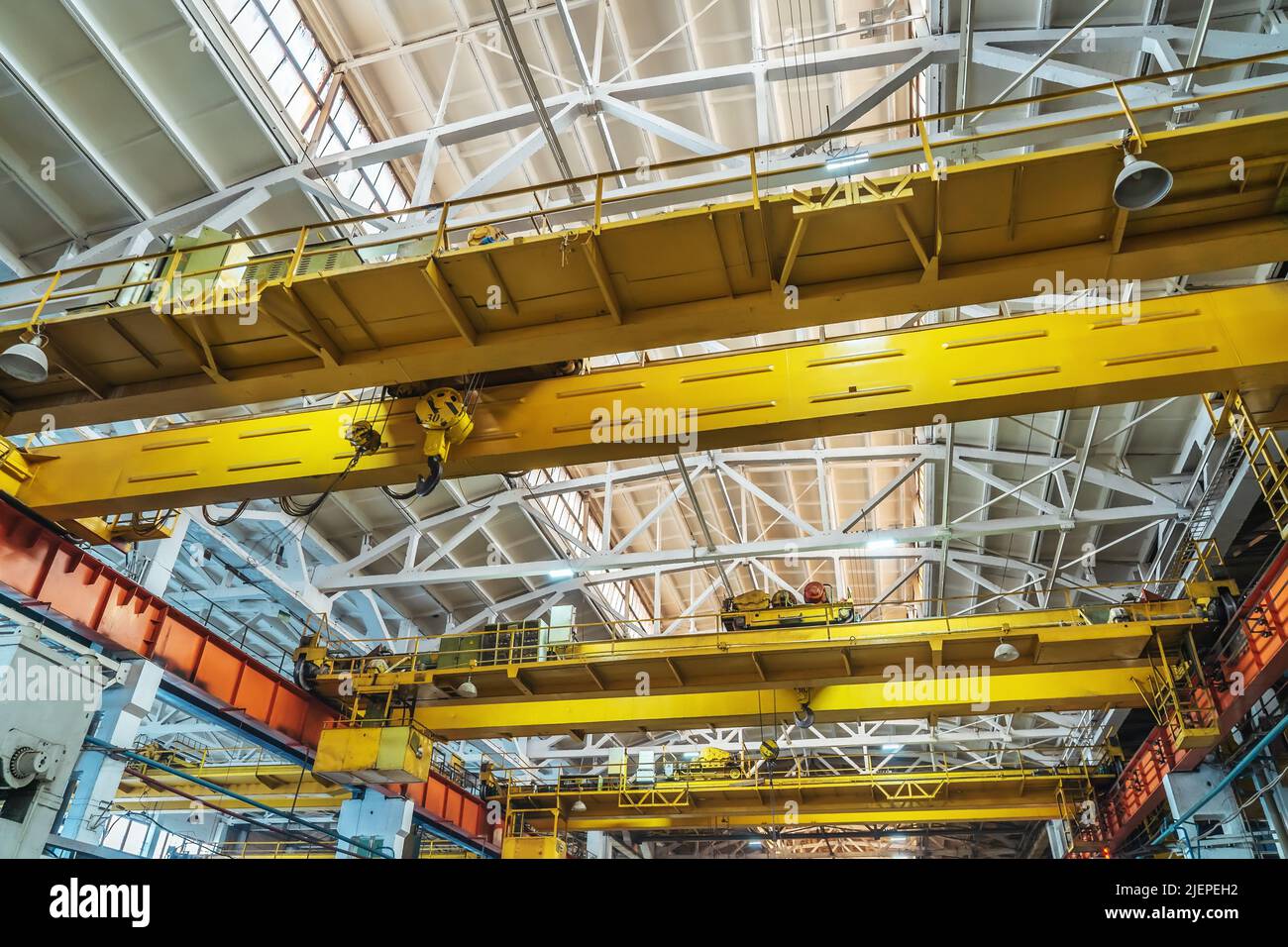 Beam cranes inside an industrial metal manufacturing plant. Stock Photo