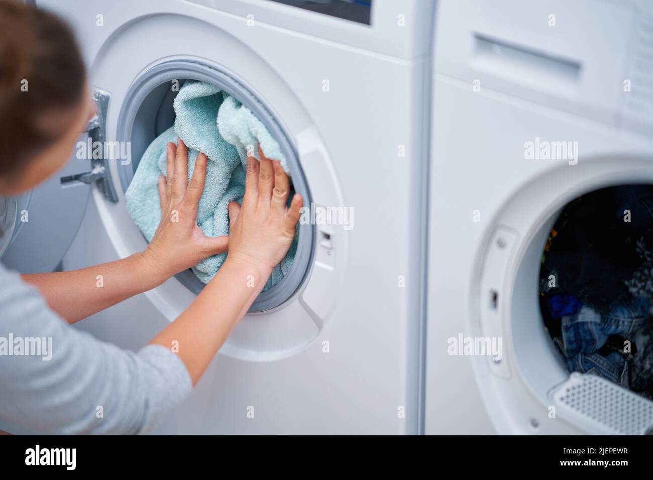 Picture of young woman making laundry work Stock Photo Alamy