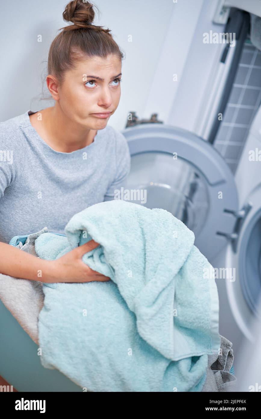 Picture of young woman making laundry work Stock Photo Alamy