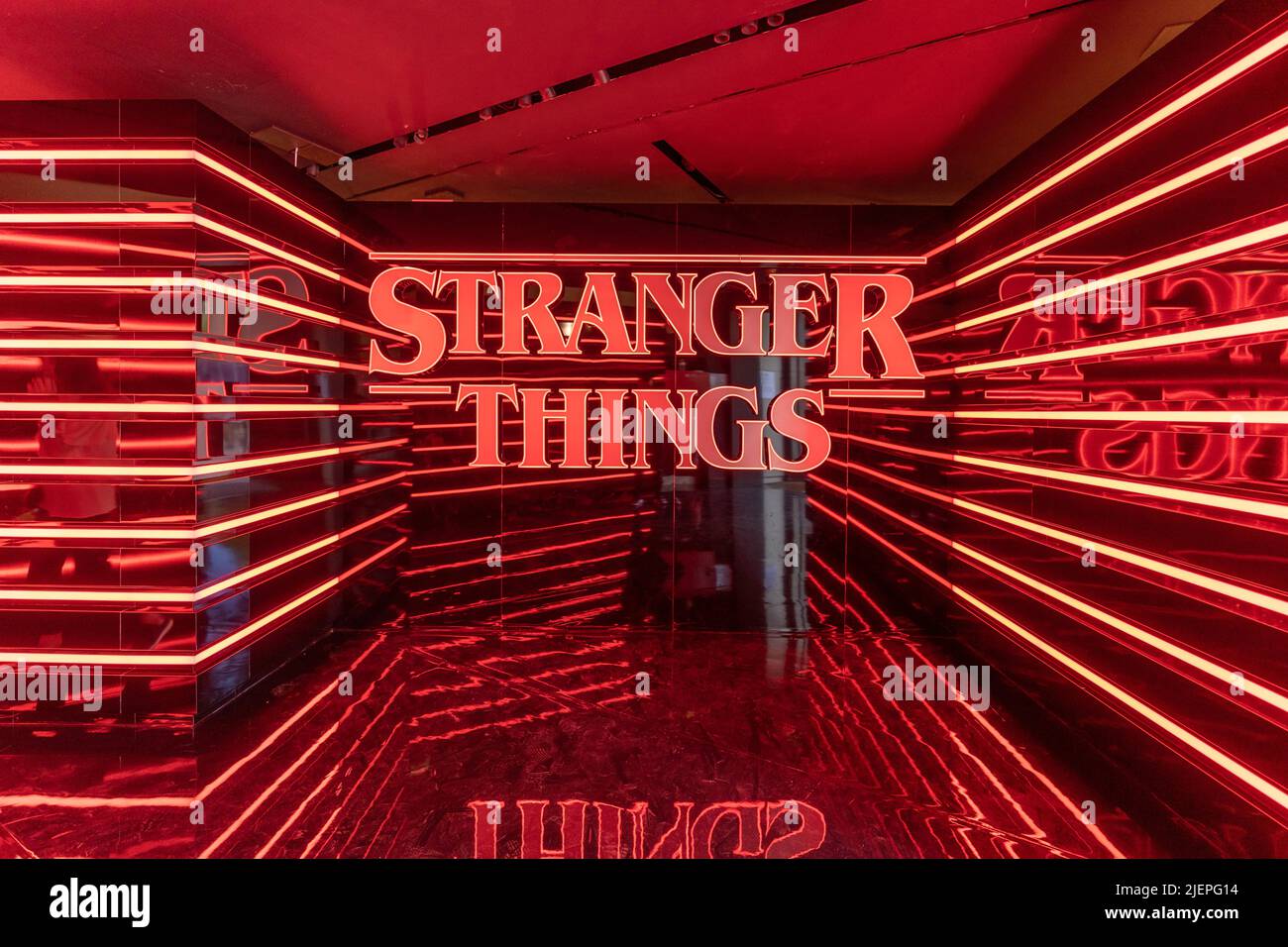 Paris, France - June 27, 2022: Red neon logo stranger things at the entrance of Pop-up store on avenue Champs Elysees Stock Photo