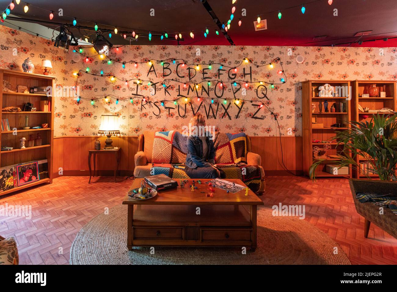 Paris, France - June 27, 2022: Tourist girl in Living room in Stranger Things Pop-up store on avenue Champs Elysees Stock Photo