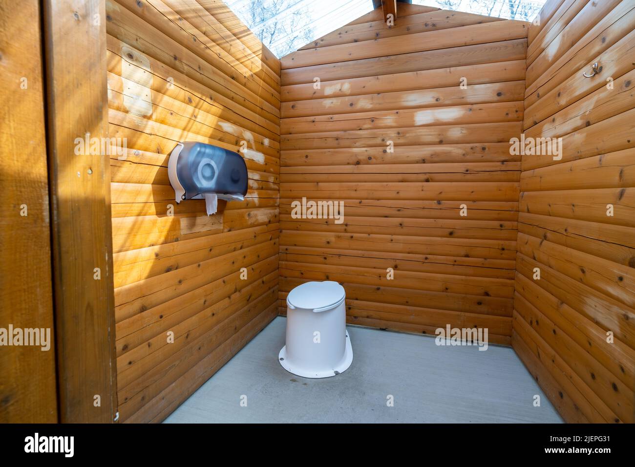 Interior of wooden public lavatory in the Jasper National Park, Alberta, Canada. Countryside toilet concept. Stock Photo
