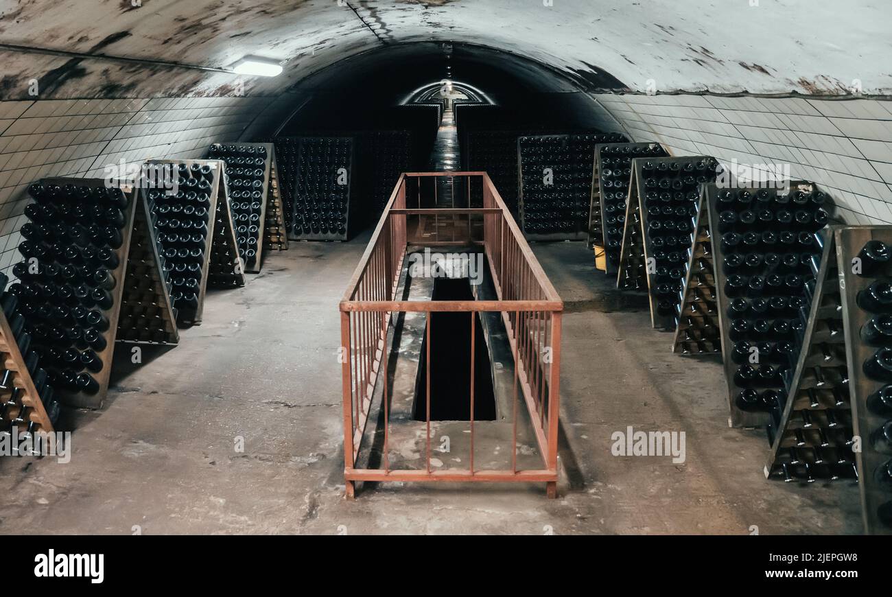 Typical underground cellar for storing and aging wine in glass bottles