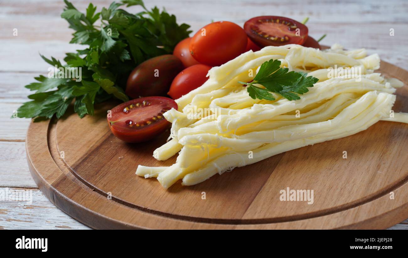 String cheese or cheese whip salty snack cheese with cherry tomatoes