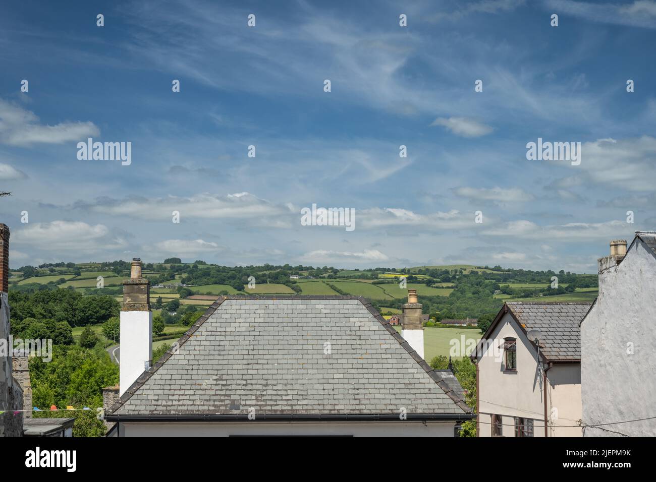 Top of roofs of houses at HayonWye with green hills visible at the