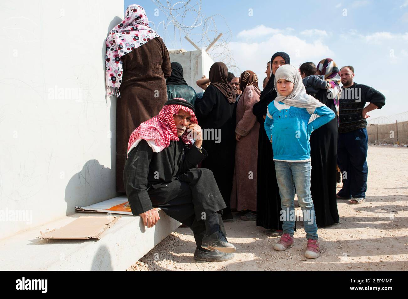 Al Za'atari, Jordan. New arrivals at the UNHCR Refugee Camp, second largest to seek safety and security from the ongoing Civil War in Syria first need to register at the main gate before they can reply on housing, food, medical care and more.. Stock Photo