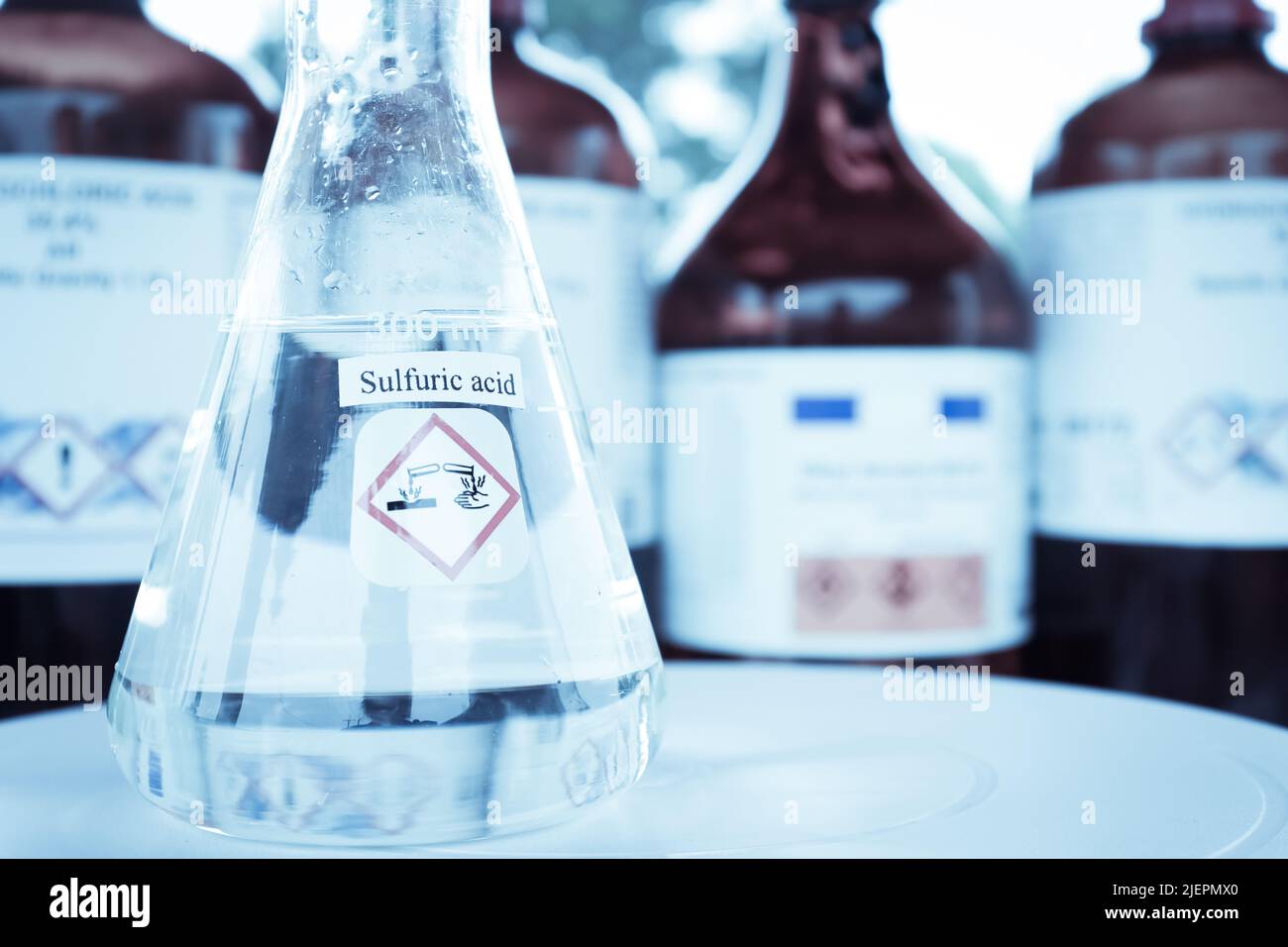 sulfuric acid in glass, chemical in the laboratory and industry Stock Photo
