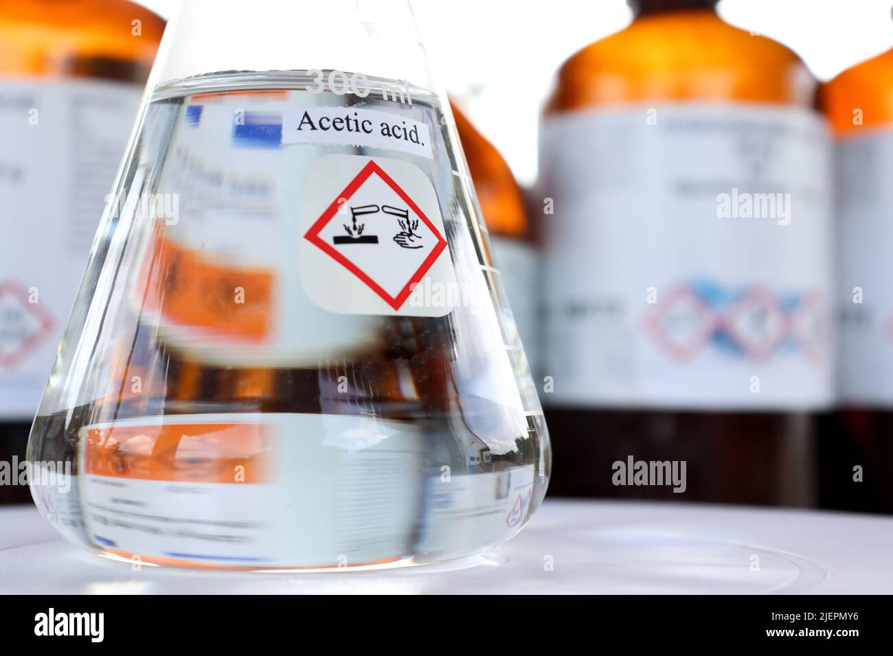 Acetic acid in glass, chemical in the laboratory and industry Stock Photo