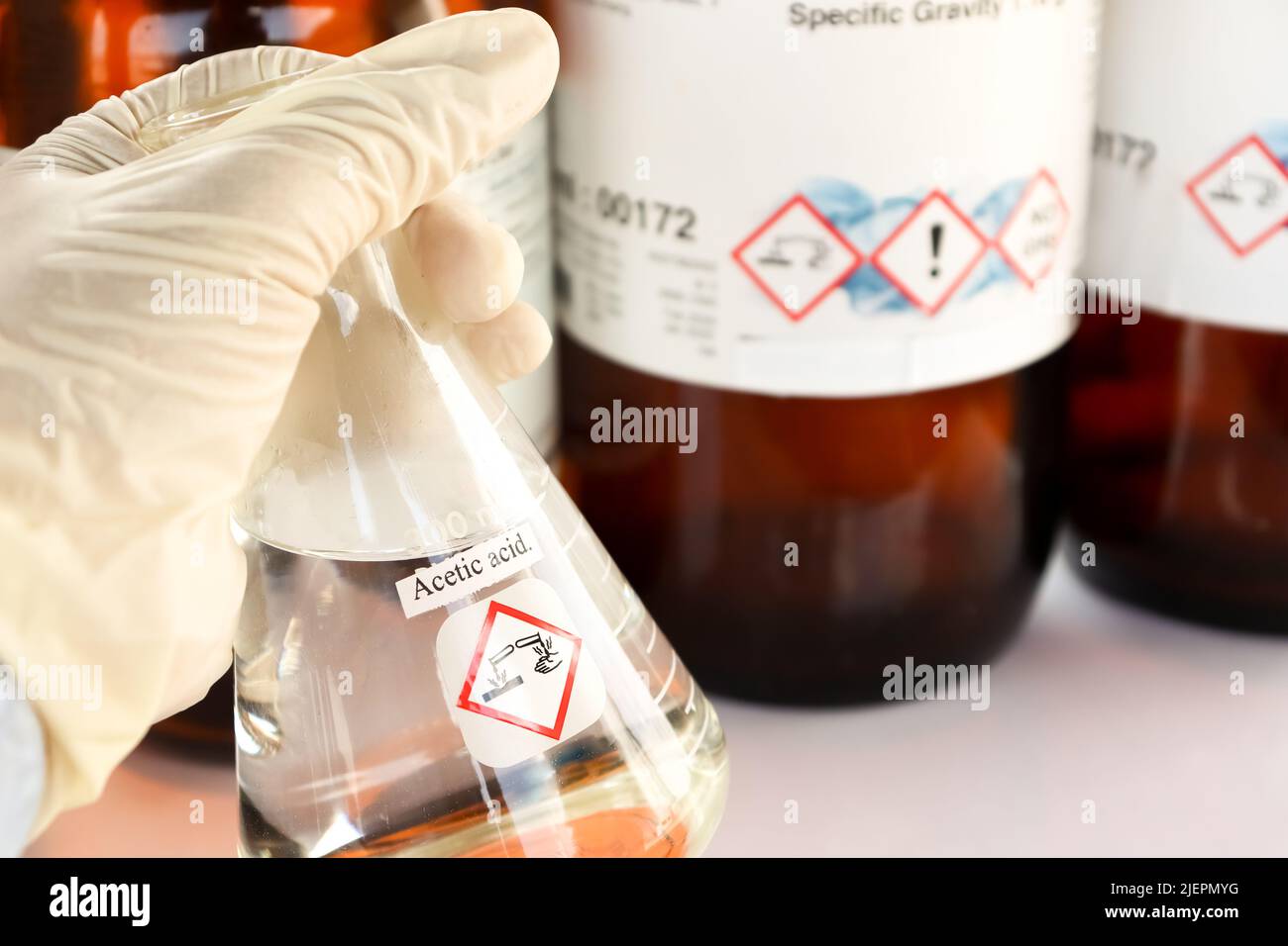 Acetic acid in glass, chemical in the laboratory and industry Stock Photo