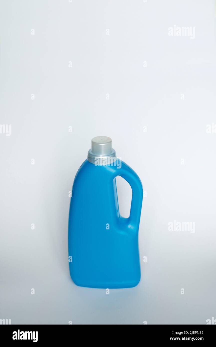 Blue plastic bottle stands on white background. Conditioner or liquid powder for washing. Capacity with space for copying. Layout for logo application Stock Photo