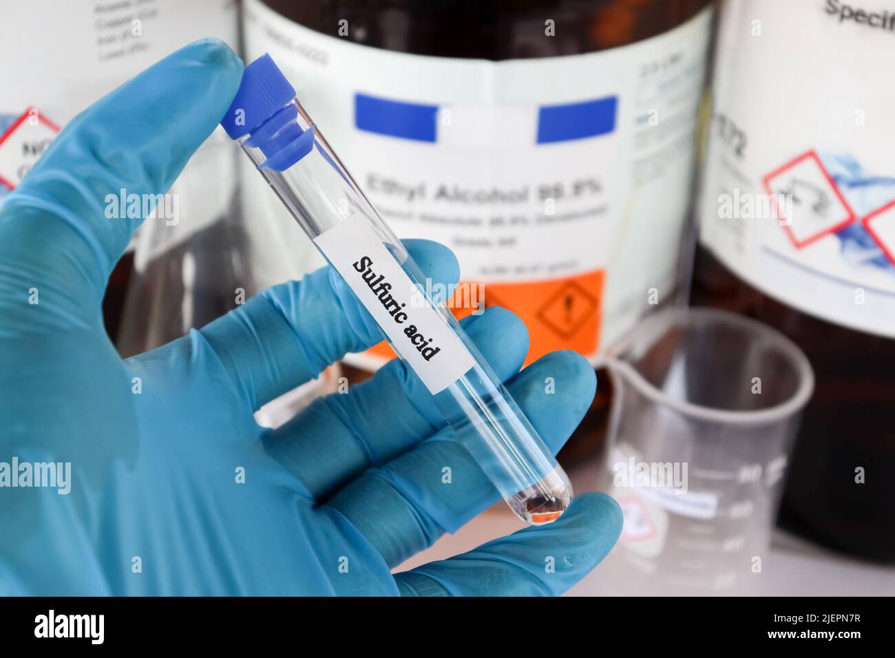 sulfuric acid in test tube used in laboratory and industry Stock Photo
