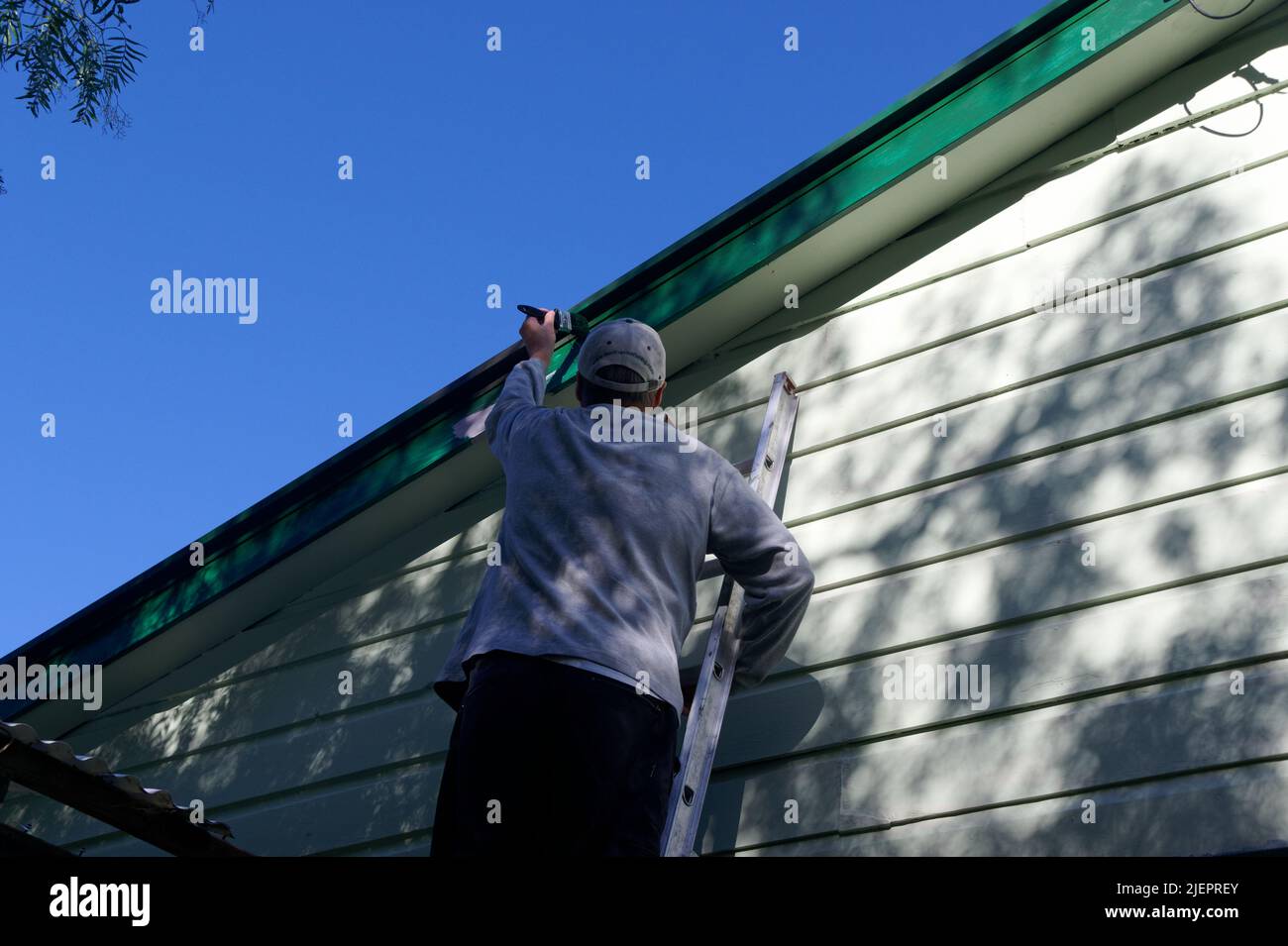 Time to paint the house, preparation has already begun with pink primer on the dark green barge