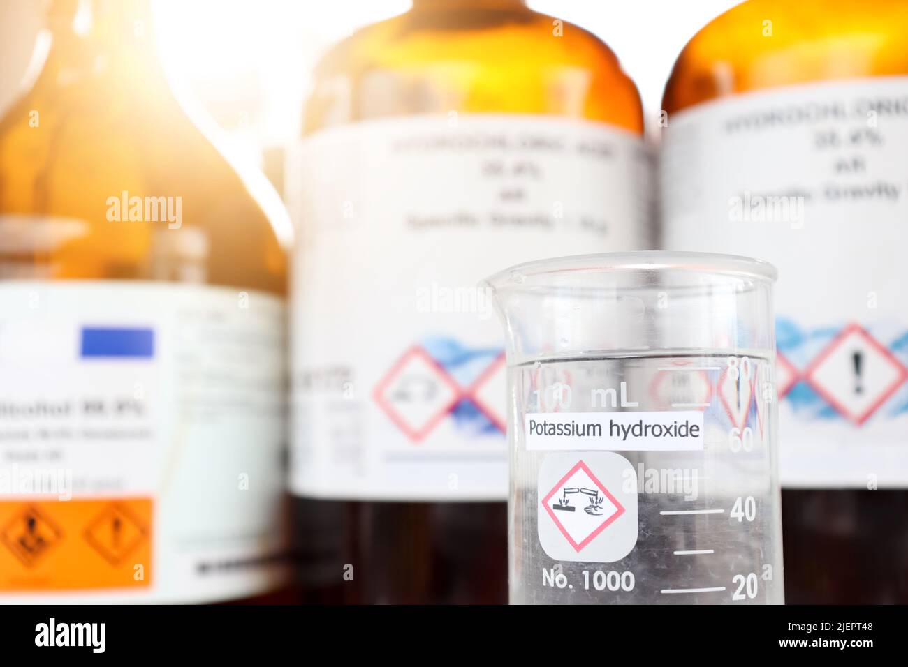 Potassium hydroxide liquid in glass, chemical in the laboratory and industry Stock Photo