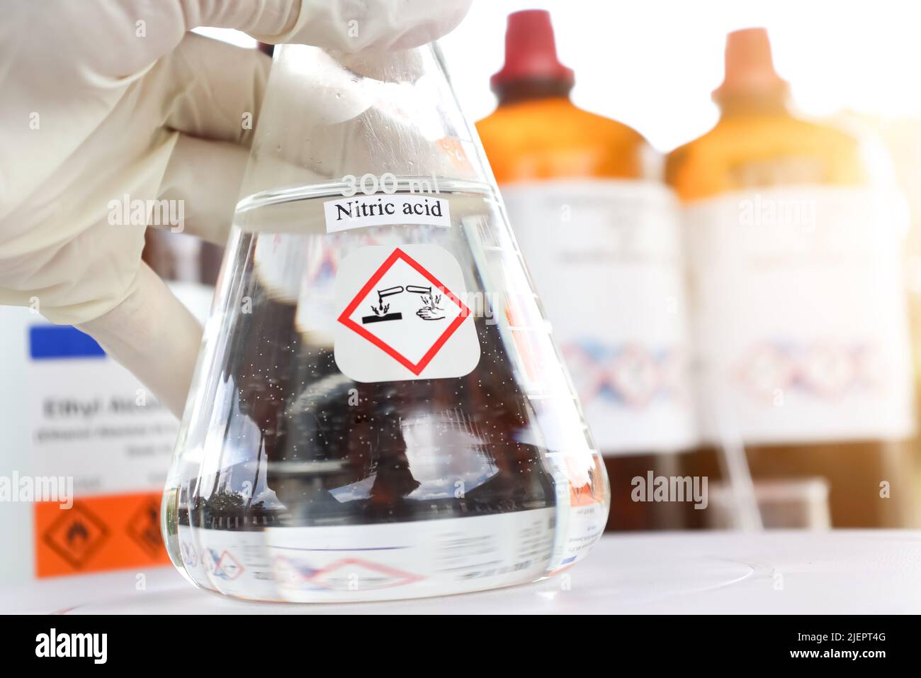 Nitric acid in glass, chemical in the laboratory and industry Stock Photo