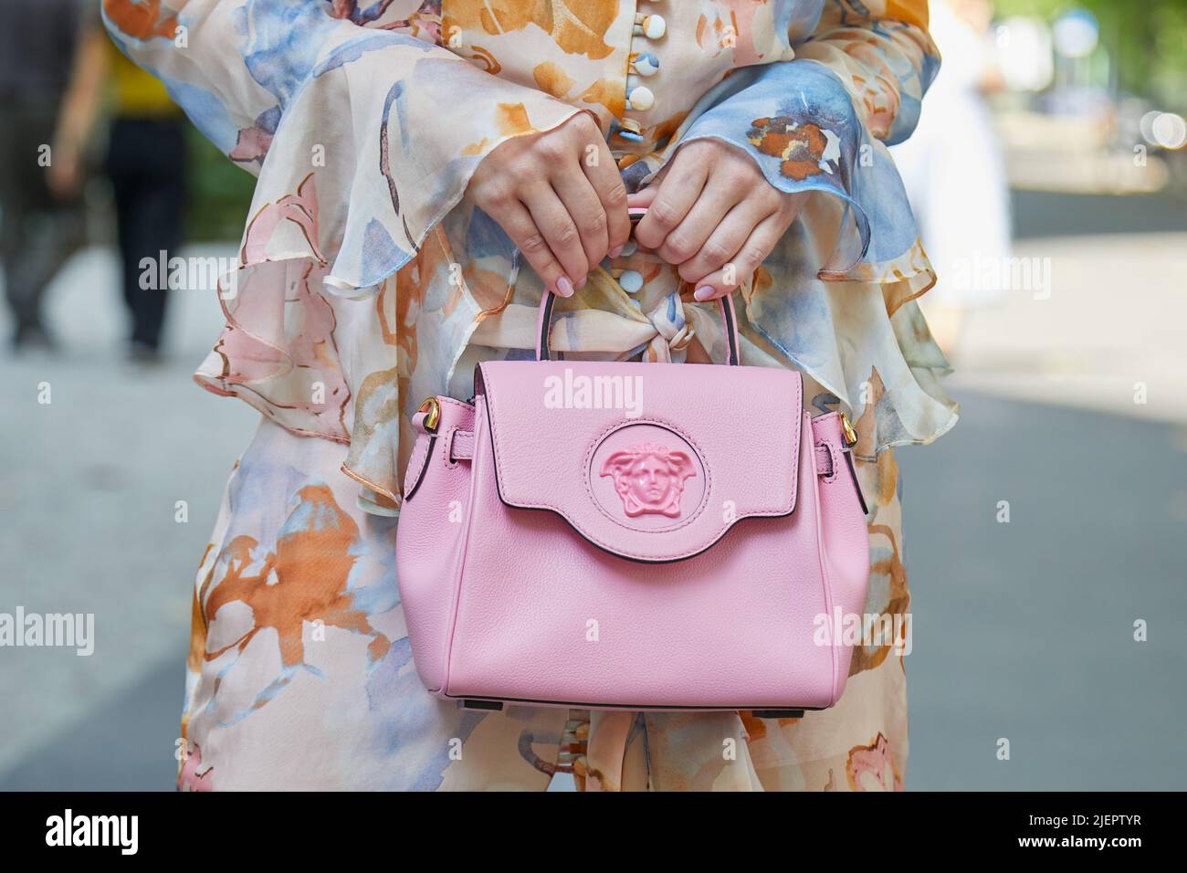 MILAN, ITALY - JUNE 19, 2022: Woman with pink leather Versace bag before  Etro fashion show, Milan Fashion Week street style Stock Photo - Alamy