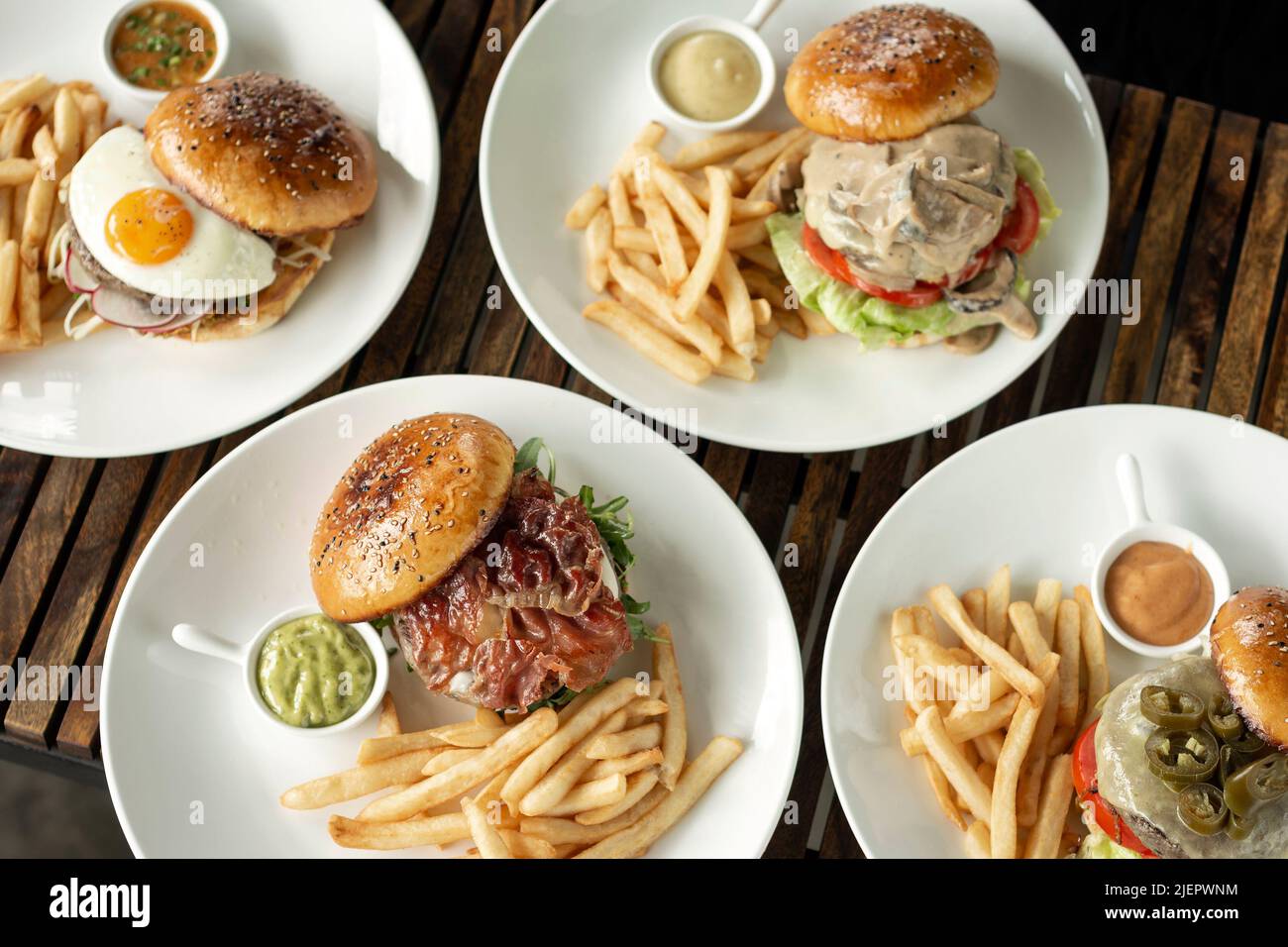 many different burgers on restaurant table Stock Photo