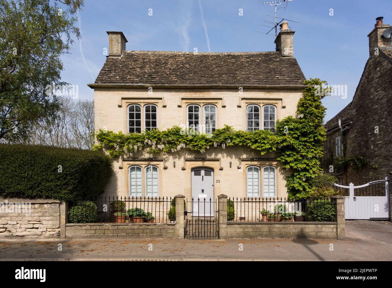 Cotswold stone cottage with wisteria, Tetbury, Gloucestershire Stock Photo