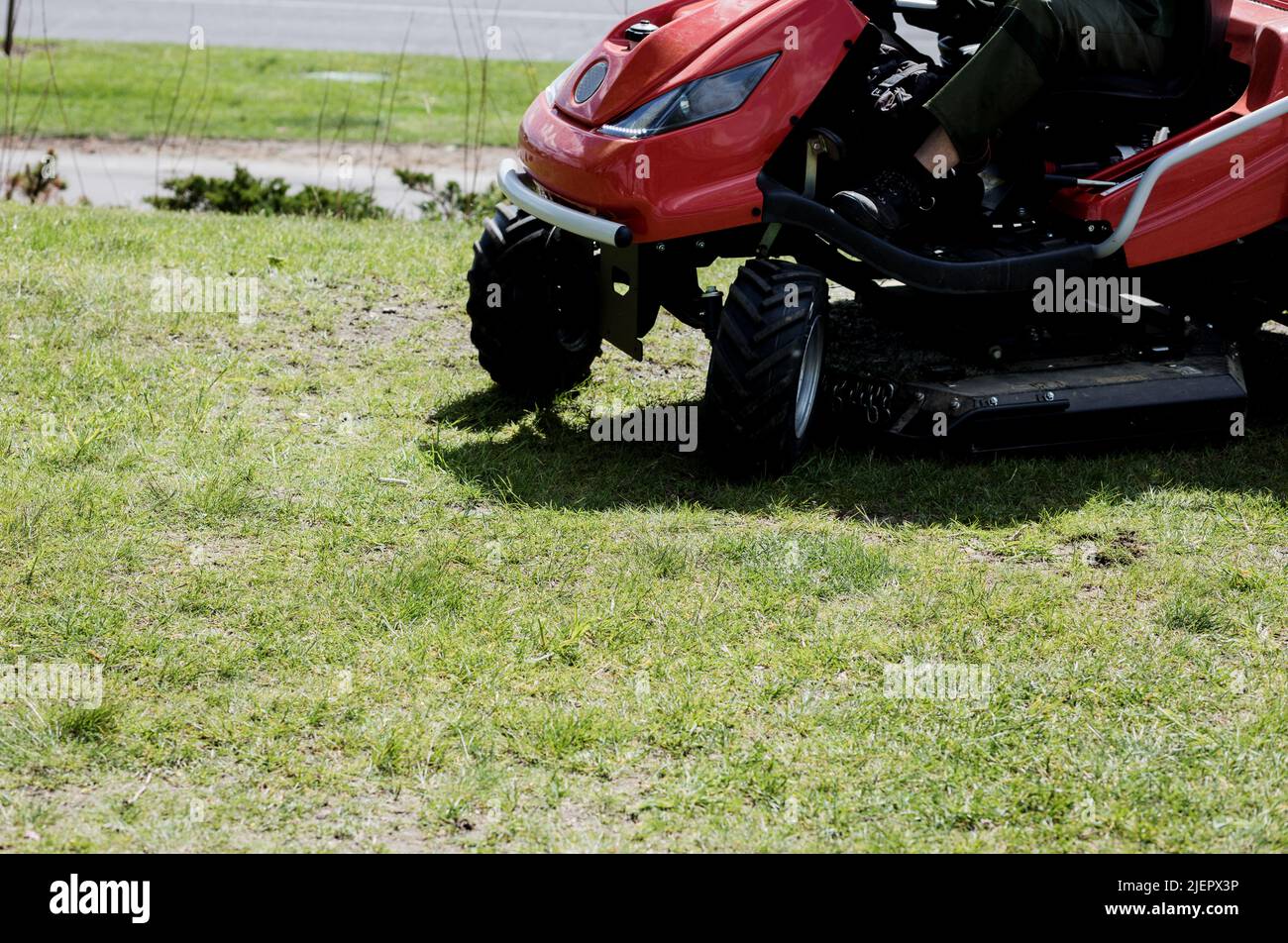 mowing the lawn on green grass. landscaping Stock Photo Alamy