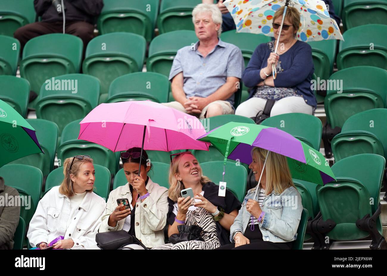 Spectators with umbrellas on day two of the 2022 Wimbledon