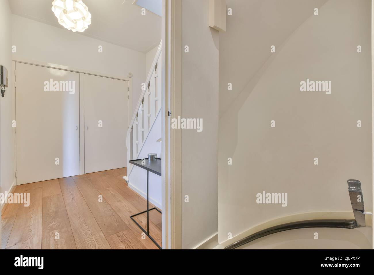 Small Penthouse Apartment With Minimalist Hallway photo