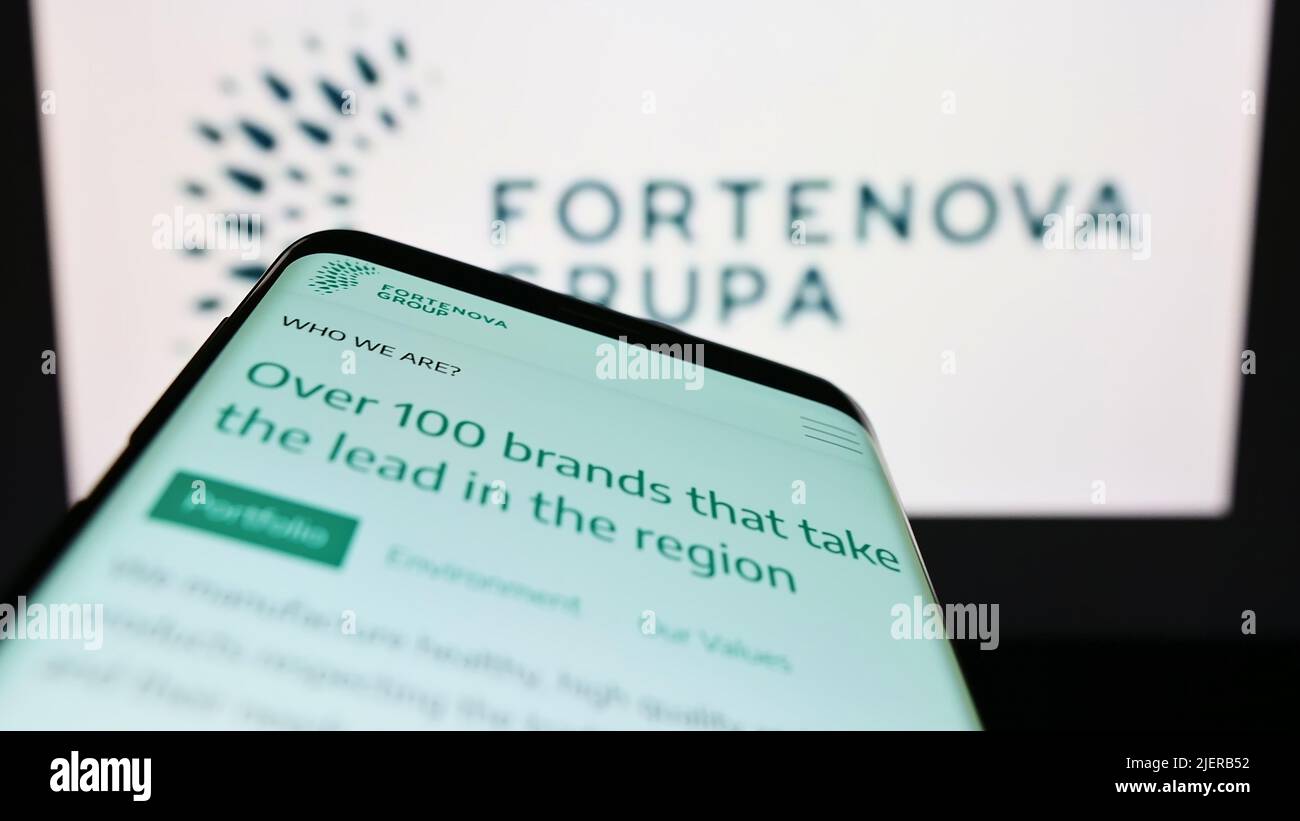 Mobile phone with website of Croatian conglomerate Fortenova Group on screen in front of business logo. Focus on top-left of phone display. Stock Photo