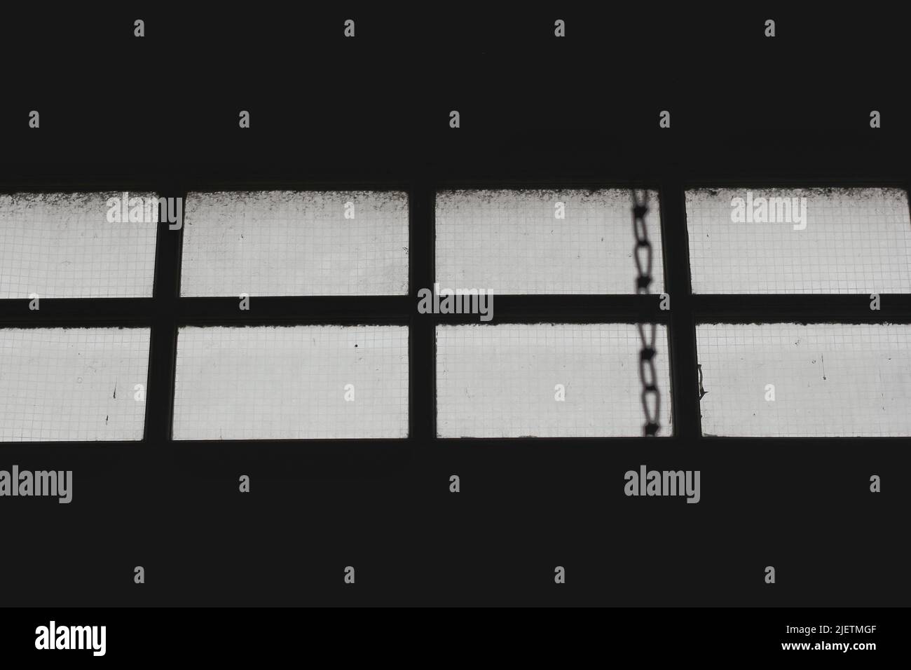 Industrial window with a pull down mechanical chain Stock Photo - Alamy