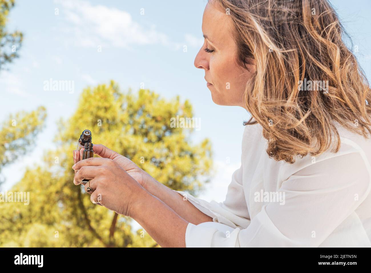 woman testing aromatherpy oils on a summertime mindfulness ritual. healthy life concept. summer solstice. Stock Photo