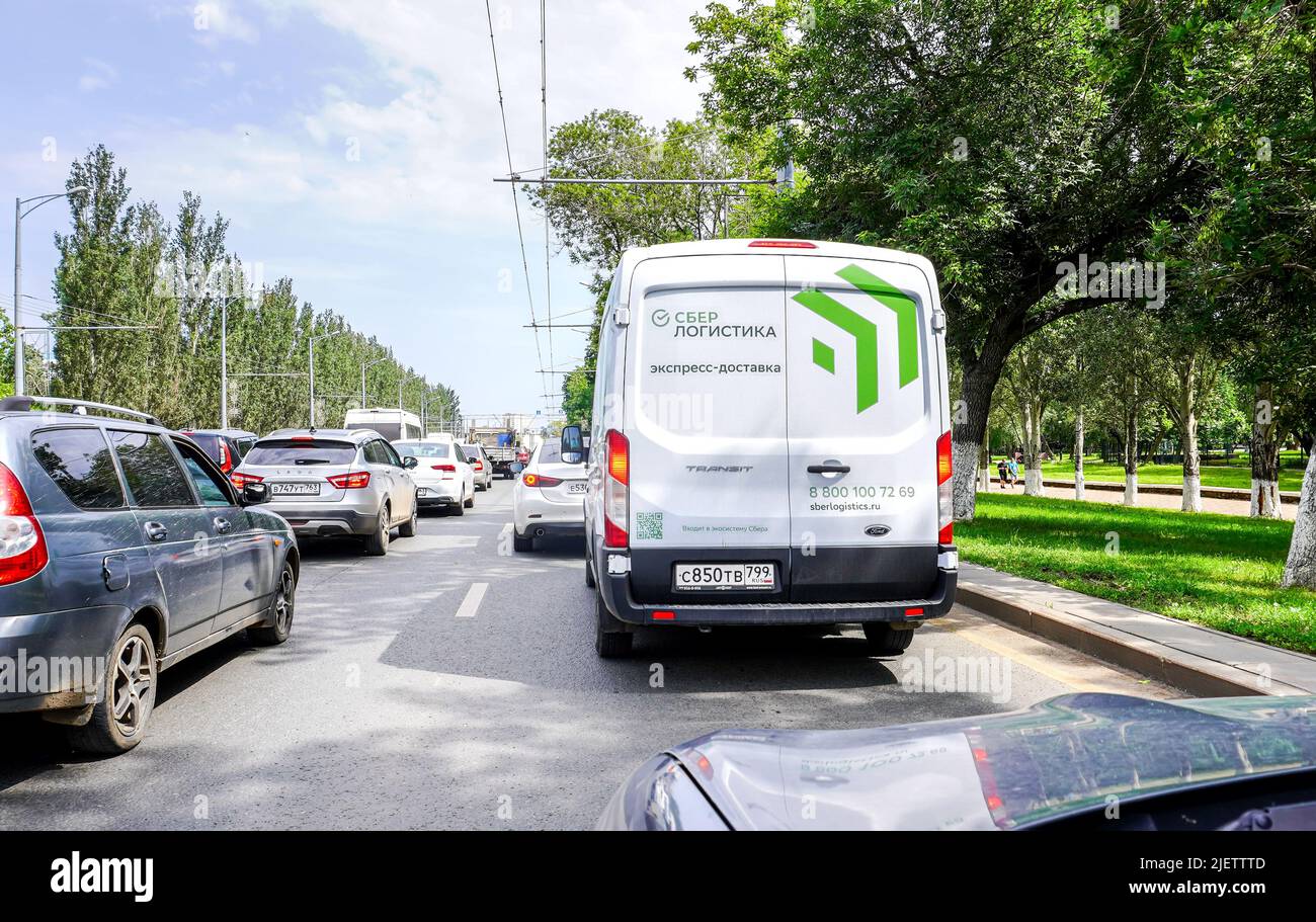 Samara, Russia - June 24, 2022: Branded cargo van of a Russian courier companies Sber Logistics. Delivery vehicle of goods from the Sber online store. Stock Photo