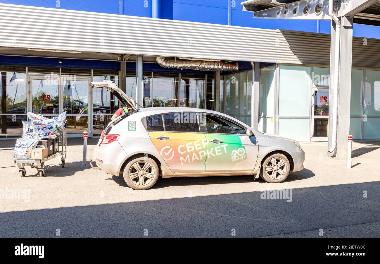 Samara, Russia - June 25, 2022: Branded vehicle of Sber Market marketplace owned by Sberbank. Delivery vehicle of goods from the Sber Market online st Stock Photo