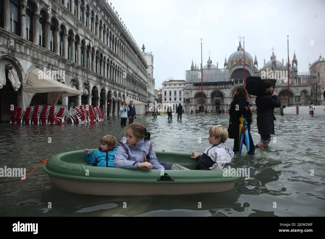 November 01-2012 Venice.Tourist walk on a flooded Saint Mark Square during a period of 'acqua alta'. Stock Photo