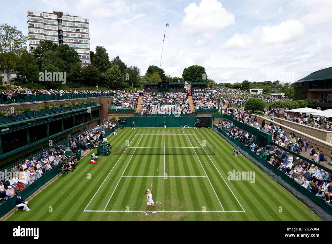Katie Swan (foreground) serves during her match against Marta Kostyuk during day two of the 2022